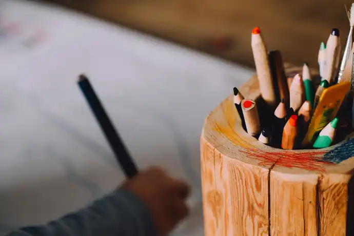 wooden pencil holder full of colored pencils